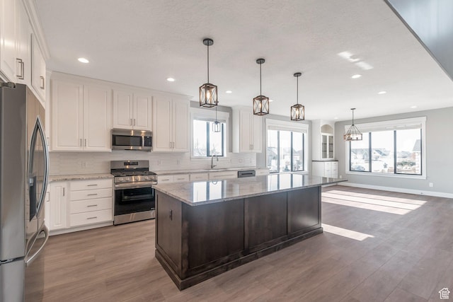 1766 S 1850 W Unit 08, Mapleton, UT 84664 - kitchen with appliances with stainless steel finishes, decorative backsplash, white cabinets, and recessed lighting