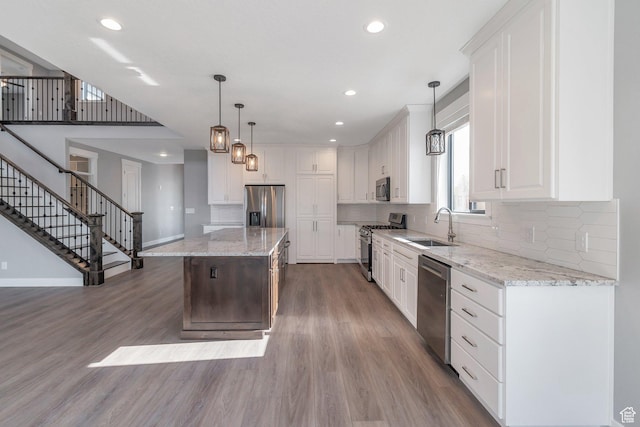 1766 S 1850 W Unit 08, Mapleton, UT 84664 - kitchen featuring appliances with stainless steel finishes, wood finished floors, recessed lighting, tasteful backsplash, and a center island