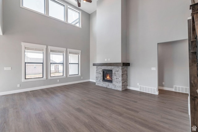 1766 S 1850 W Unit 08, Mapleton, UT 84664 - unfurnished living room with a towering ceiling, a fireplace, ceiling fan, and dark wood-type flooring