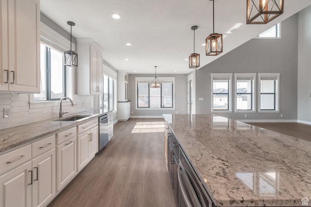 1766 S 1850 W Unit 08, Mapleton, UT 84664 - kitchen with stainless steel dishwasher, a chandelier, decorative backsplash, recessed lighting, and white cabinets
