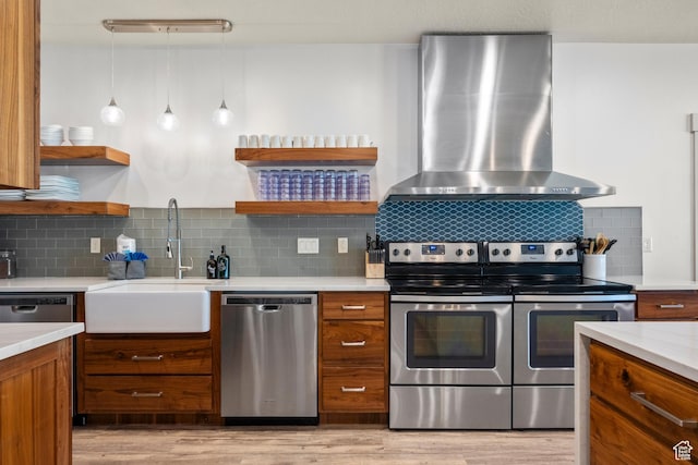 175 S Blue Topaz Ln, Garden City, UT 84028 - kitchen with appliances with stainless steel finishes, wall chimney exhaust hood, open shelves, and brown cabinetry