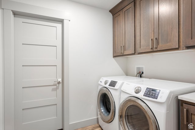 175 S Blue Topaz Ln, Garden City, UT 84028 - washroom featuring cabinet space, separate washer and dryer, and light wood-style flooring