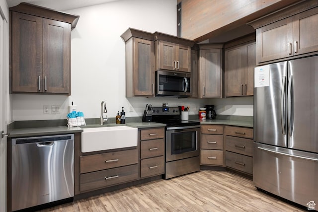 175 S Blue Topaz Ln, Garden City, UT 84028 - kitchen featuring appliances with stainless steel finishes, light wood finished floors, and dark brown cabinets