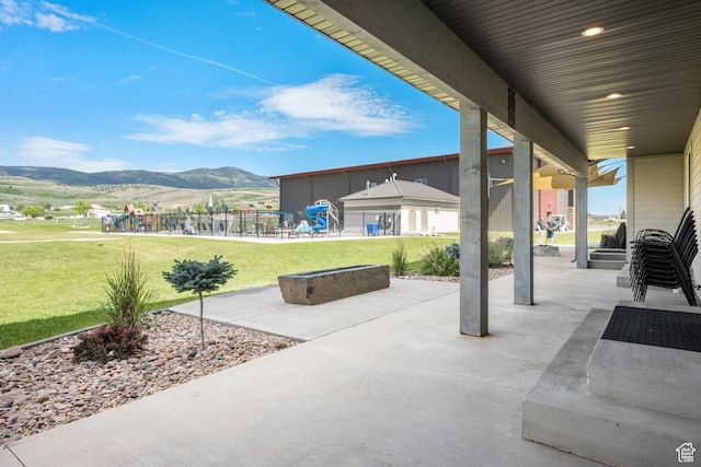 175 S Blue Topaz Ln, Garden City, UT 84028 - view of patio with a playground and a mountain view