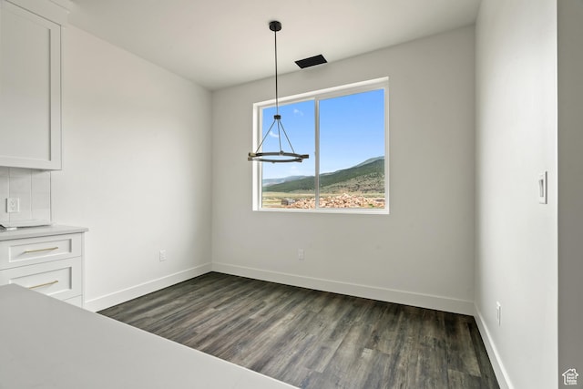 2639 S Mann Ln, Cedar City, UT 84720 - unfurnished dining area with dark wood-style floors and baseboards