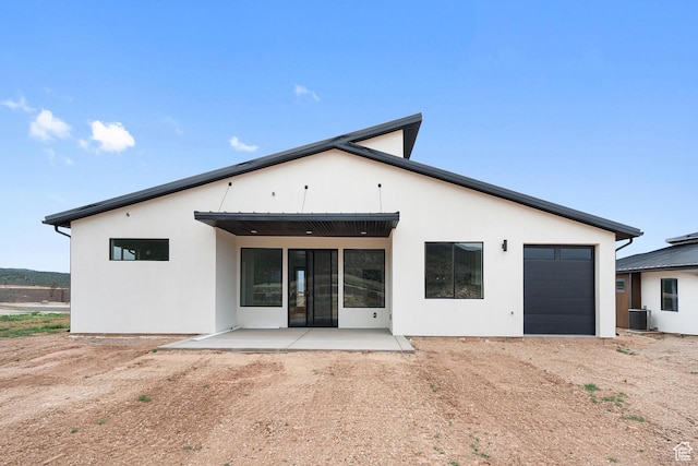 2639 S Mann Ln, Cedar City, UT 84720 - back of house featuring a garage, driveway, a patio area, and stucco siding