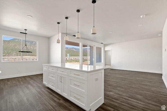 2639 S Mann Ln, Cedar City, UT 84720 - kitchen with dark wood-style floors, white cabinets, light countertops, decorative light fixtures, and a center island