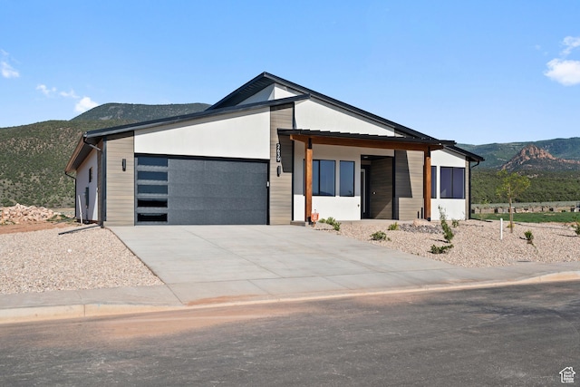 2639 S Mann Ln, Cedar City, UT 84720 - contemporary home with a mountain view, an attached garage, and concrete driveway