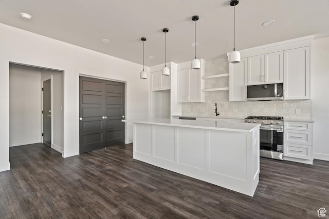 2639 S Mann Ln, Cedar City, UT 84720 - kitchen with appliances with stainless steel finishes, backsplash, dark wood-type flooring, white cabinetry, and open shelves