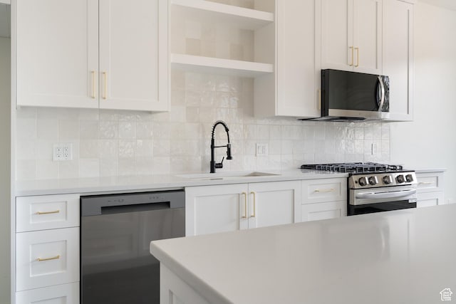 2639 S Mann Ln, Cedar City, UT 84720 - kitchen with appliances with stainless steel finishes, open shelves, light countertops, and white cabinetry