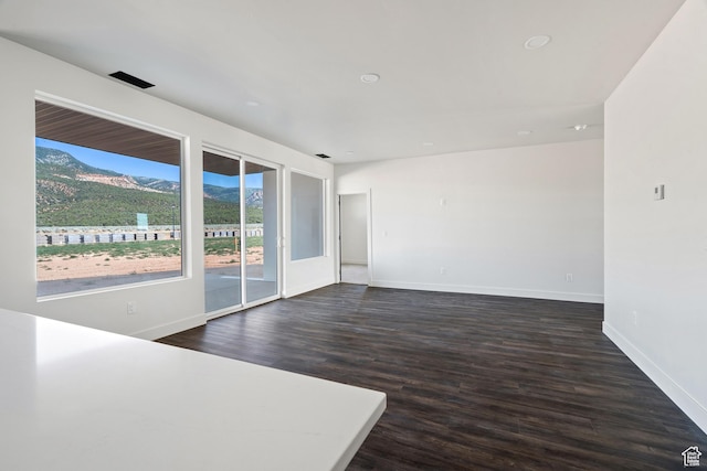 2639 S Mann Ln, Cedar City, UT 84720 - empty room featuring a mountain view, dark wood-style floors, and recessed lighting