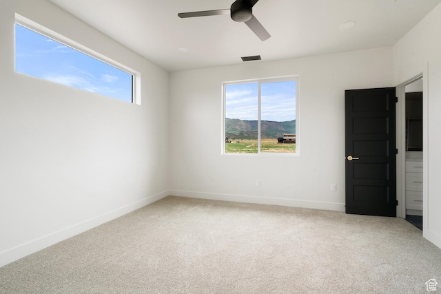 2639 S Mann Ln, Cedar City, UT 84720 - spare room featuring carpet, a ceiling fan, and a mountain view