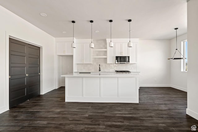 2639 S Mann Ln, Cedar City, UT 84720 - kitchen with stainless steel microwave, white cabinets, tasteful backsplash, light countertops, and a kitchen island