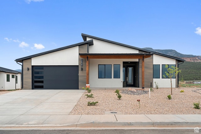 2639 S Mann Ln, Cedar City, UT 84720 - contemporary home featuring an attached garage, concrete driveway, and a mountain view