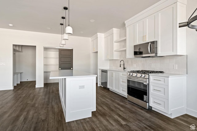 2639 S Mann Ln, Cedar City, UT 84720 - kitchen featuring appliances with stainless steel finishes, open shelves, light countertops, tasteful backsplash, and dark wood-style floors