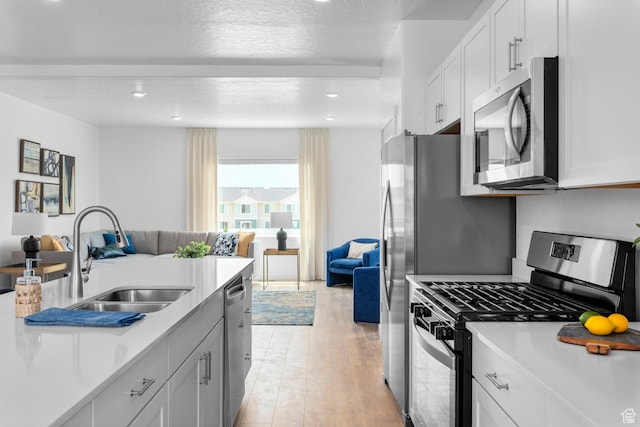 1282 N 375 E Unit 150, Harrisville, UT 84404 - kitchen featuring stainless steel appliances, open floor plan, light countertops, light wood-style flooring, and recessed lighting