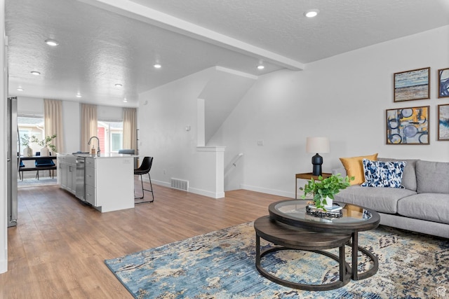1282 N 375 E Unit 150, Harrisville, UT 84404 - living area with light wood-style flooring, a textured ceiling, and recessed lighting