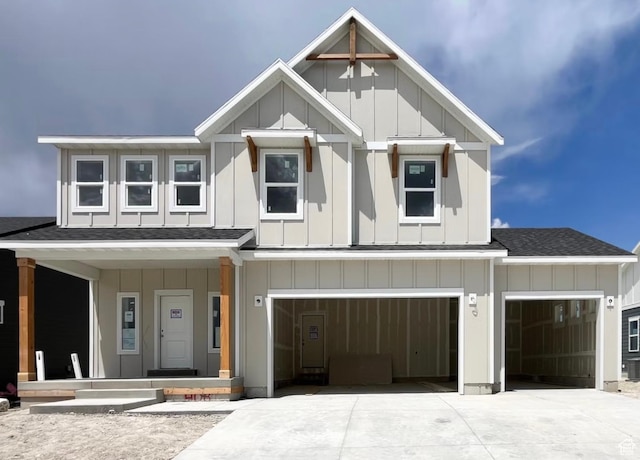 1145 E Harrier St Unit 307, Eagle Mountain, UT 84005 - view of front facade with board and batten siding, roof with shingles, driveway, covered porch, and a garage