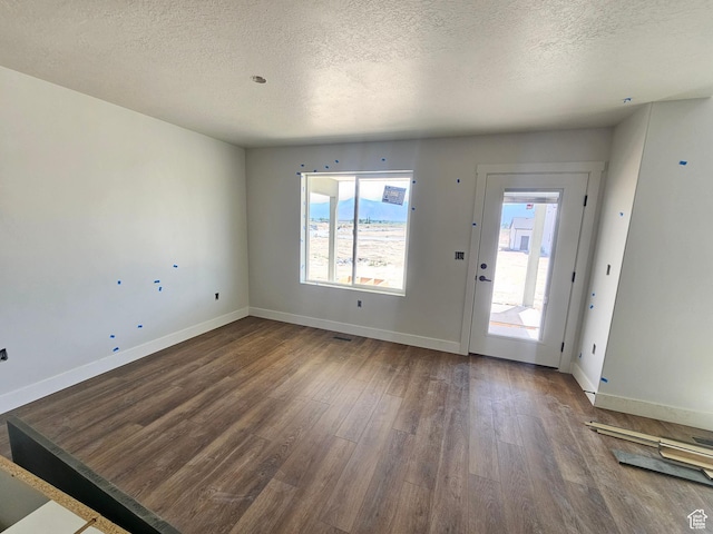 1726 S 3875 W Unit 225, West Weber, UT 84401 - unfurnished living room with a textured ceiling and wood finished floors
