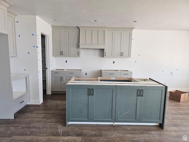1726 S 3875 W Unit 225, West Weber, UT 84401 - kitchen featuring a kitchen island, a textured ceiling, dark wood finished floors, freestanding refrigerator, and gray cabinets