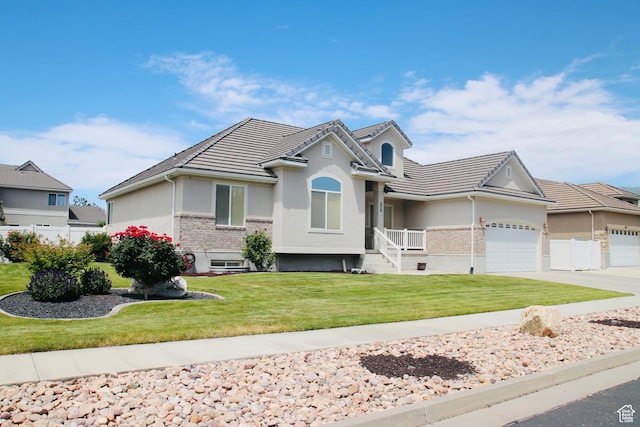 270 Amsterdam Dr, Stansbury Park, UT 84074 - single story home featuring stucco siding, an attached garage, driveway, and a tiled roof