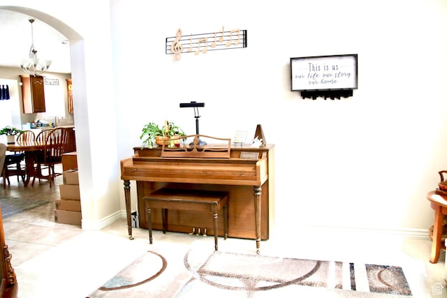 270 Amsterdam Dr, Stansbury Park, UT 84074 - sitting room featuring a chandelier, light tile patterned floors, and arched walkways