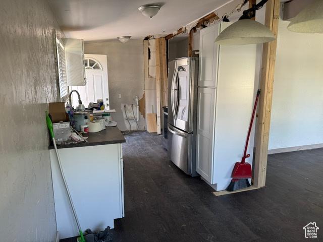 112 N Quincy Ave E, Ogden, UT 84404 - kitchen featuring freestanding refrigerator, dark countertops, dark wood-style floors, and white cabinetry