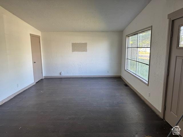 112 N Quincy Ave E, Ogden, UT 84404 - empty room featuring vaulted ceiling and dark wood-style flooring