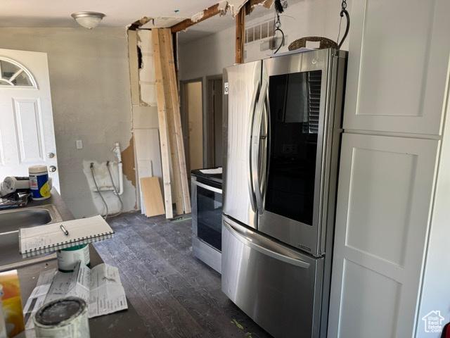 112 N Quincy Ave E, Ogden, UT 84404 - kitchen with appliances with stainless steel finishes and dark wood-type flooring