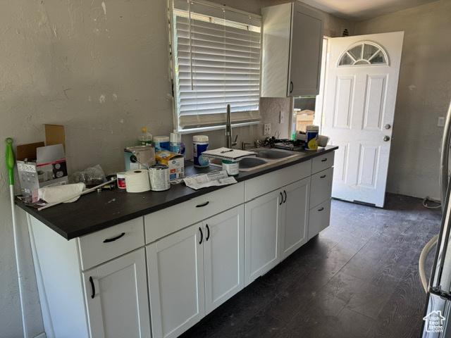 112 N Quincy Ave E, Ogden, UT 84404 - kitchen featuring dark countertops, white cabinetry, and dark wood-style flooring
