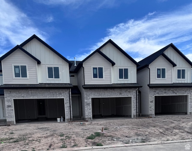 211 W 815 N Unit 19, Nephi, UT 84648 - view of front of property with board and batten siding, a garage, and stone siding