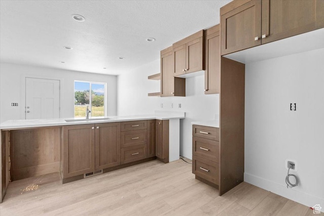 211 W 815 N Unit 19, Nephi, UT 84648 - kitchen with light wood-type flooring, a peninsula, light countertops, and recessed lighting