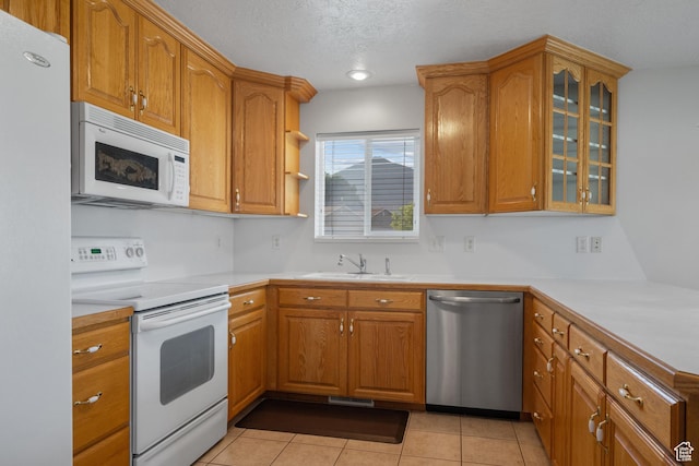 347 N 220 W, Salem, UT 84653 - kitchen featuring white appliances, glass insert cabinets, brown cabinetry, and a textured ceiling
