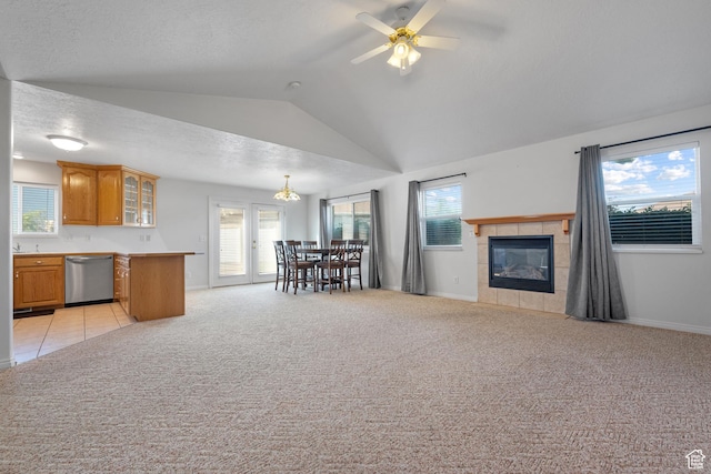 347 N 220 W, Salem, UT 84653 - living room featuring vaulted ceiling, a ceiling fan, healthy amount of natural light, a tile fireplace, and light carpet