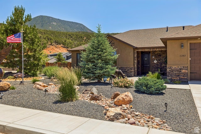 1283 W 1750 S, Cedar City, UT 84720 - view of front of property featuring a mountain view, stone siding, an attached garage, and a shingled roof