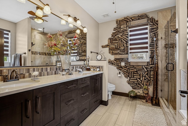 1283 W 1750 S, Cedar City, UT 84720 - bathroom featuring a ceiling fan, double vanity, a shower stall, and decorative backsplash