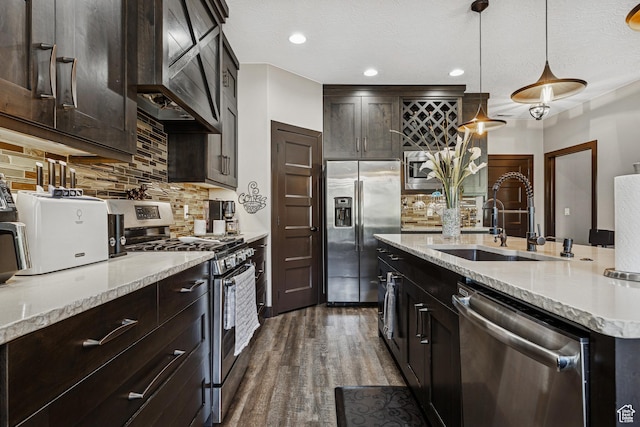 1283 W 1750 S, Cedar City, UT 84720 - kitchen with stainless steel appliances, wall chimney exhaust hood, tasteful backsplash, dark wood-type flooring, and light stone counters