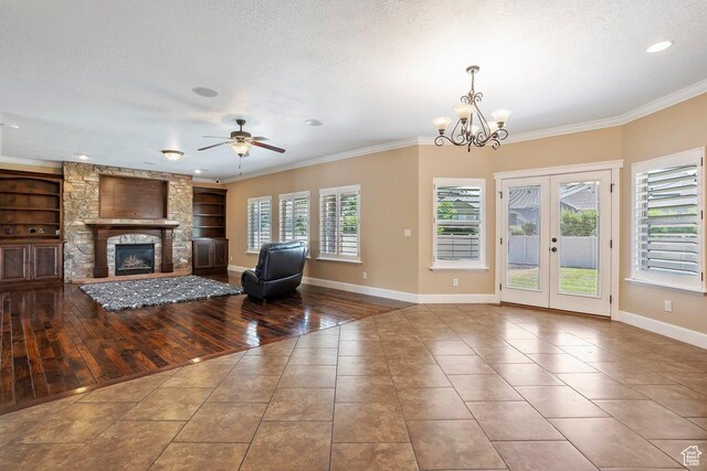 2131 S 1230 W, Syracuse, UT 84075 - living room with tile patterned flooring, ornamental molding, a ceiling fan, built in shelves, and a fireplace