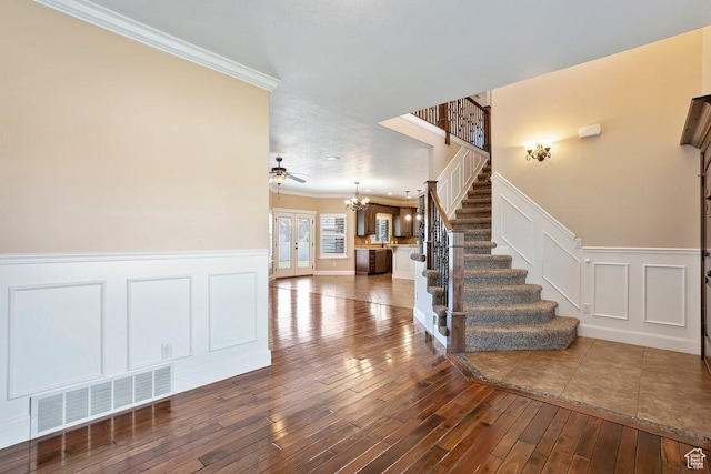 2131 S 1230 W, Syracuse, UT 84075 - entrance foyer with stairway, crown molding, wood-type flooring, a chandelier, and a decorative wall