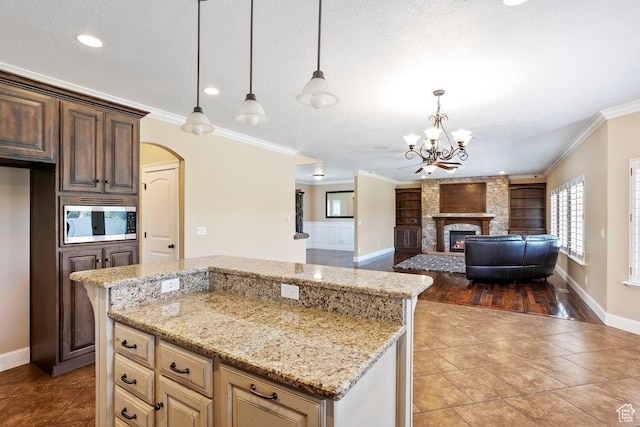 2131 S 1230 W, Syracuse, UT 84075 - kitchen featuring stainless steel microwave, built in shelves, a chandelier, tile patterned floors, and crown molding