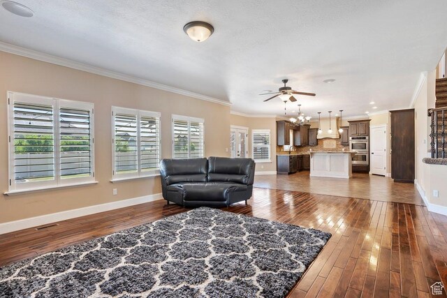 2131 S 1230 W, Syracuse, UT 84075 - living room with dark wood-style flooring, crown molding, and a ceiling fan