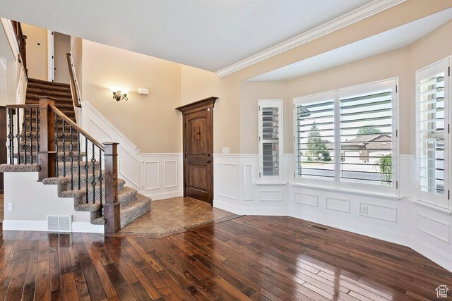 2131 S 1230 W, Syracuse, UT 84075 - foyer featuring hardwood / wood-style flooring, a decorative wall, wainscoting, stairs, and crown molding