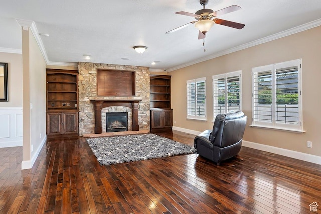 2131 S 1230 W, Syracuse, UT 84075 - living room with built in shelves, hardwood / wood-style floors, crown molding, ceiling fan, and a stone fireplace