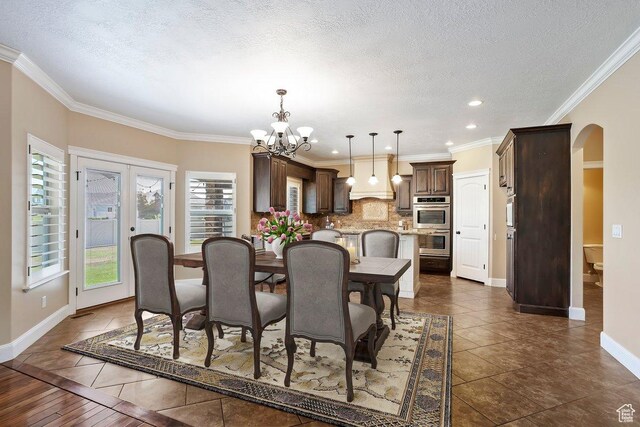 2131 S 1230 W, Syracuse, UT 84075 - dining room featuring arched walkways, a chandelier, dark tile patterned floors, a textured ceiling, and recessed lighting