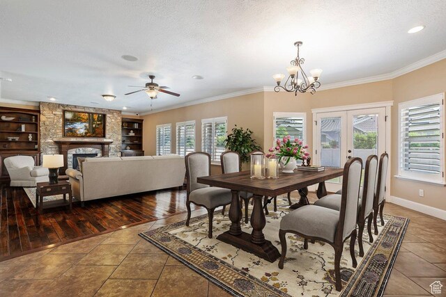 2131 S 1230 W, Syracuse, UT 84075 - tiled dining room with crown molding, a ceiling fan, a fireplace, a chandelier, and built in features