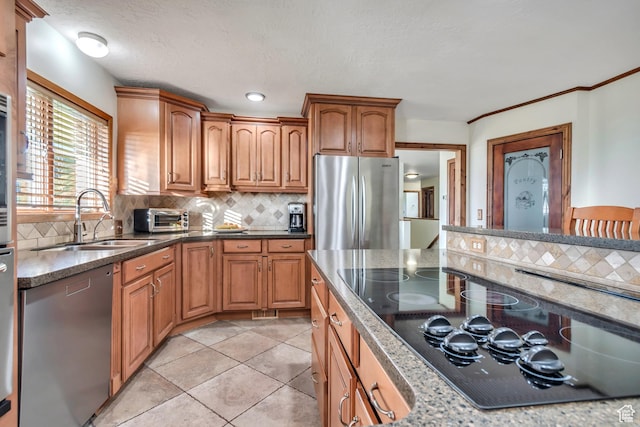 685 S Woodland Hills Dr, Woodland Hills, UT 84653 - kitchen with appliances with stainless steel finishes, tasteful backsplash, brown cabinets, dark stone counters, and light tile patterned flooring