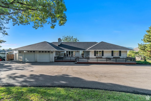 685 S Woodland Hills Dr, Woodland Hills, UT 84653 - single story home featuring brick siding, an attached garage, covered porch, and a chimney