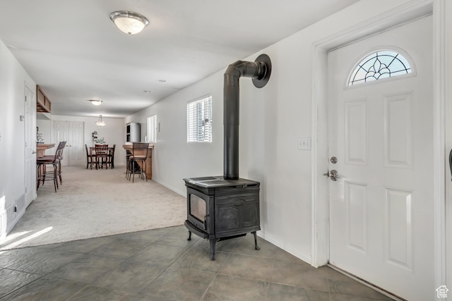 685 S Woodland Hills Dr, Woodland Hills, UT 84653 - foyer with healthy amount of natural light, a wood stove, and dark carpet