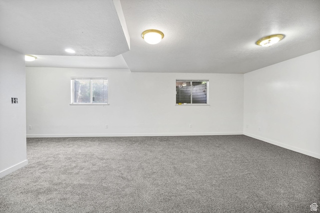 672 E Center St, Providence, UT 84332 - carpeted empty room with baseboards and a textured ceiling