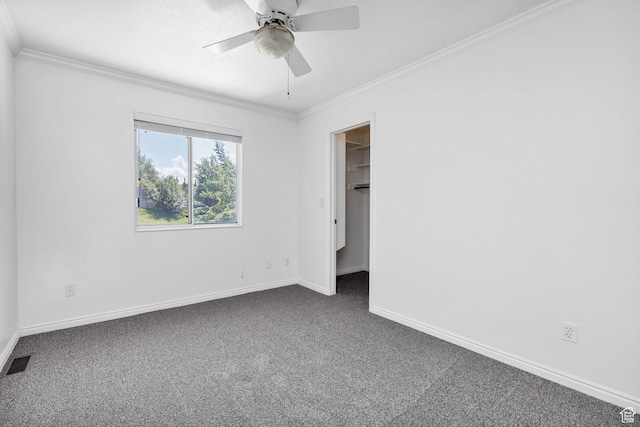 672 E Center St, Providence, UT 84332 - unfurnished bedroom with dark carpet, crown molding, a walk in closet, and a ceiling fan
